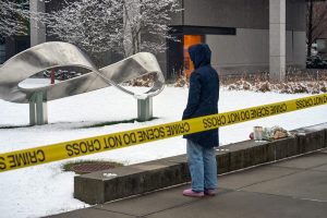 A person mourns at a makeshift memorial outside the Barus and Holley engineering building on the campus of Brown University in Providence, R.I., on Dec. 14, 2025.