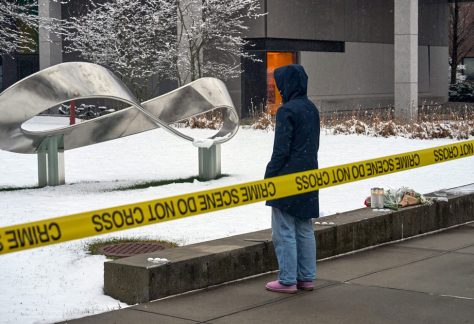 A person mourns at a makeshift memorial outside the Barus and Holley engineering building on the campus of Brown University in Providence, R.I., on Dec. 14, 2025.