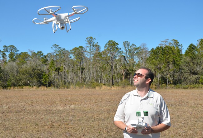 CAVU Aerial Photography's Scott Barry, demonstrating his Phantom drone in Palm Coast's Town Center last week, has operated his company in town since August. Click on the image for larger view. (© FlaglerLive)