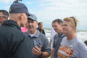 Gov. Rick Scott speaking eye-to-eye with, from left, Superintendent Jacob Oliva, Deputy Superintendent Vern Orndorff, and School Board Chairman Colleen Conklin this morning in Flagler Beach. Click on the image for larger view. (c FlaglerLive)