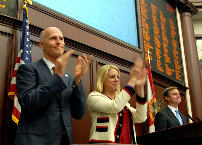 He has reasons to applaud:  Florida Gov. Rick Scott with Attorney General Pam Bondi and House Speaker Dean Cannon, R-Winter Park, right, celebate unanimous approval of pill-mill legislation in the House late Friday, May 6. (Meredith Geddings)