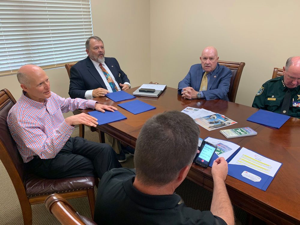 Sen. Rick Scott, left, meeting witgh Teens in Flight leaders on Monday in Palm Coast, including Jack Howell, the organization's founder (third from left) and Sheriff Rick Staly. (Facebook)