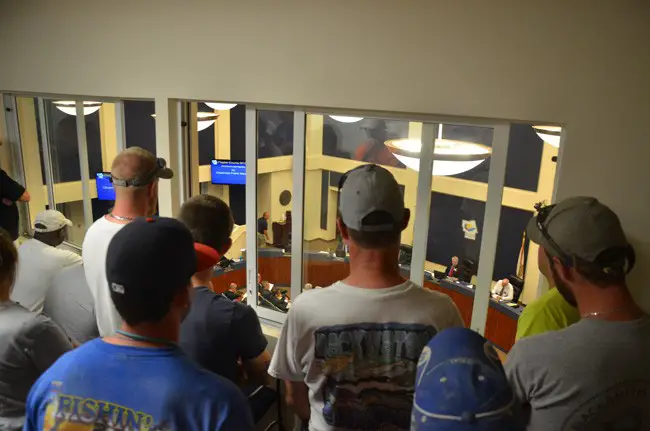 Dozens of Sea Ray employees were among an overflow crowd at the County Commission meeting this evening, requiring the audience to spill into two separate rooms, one of them the mezzanine above the commission chambers. (c FlaglerLive)