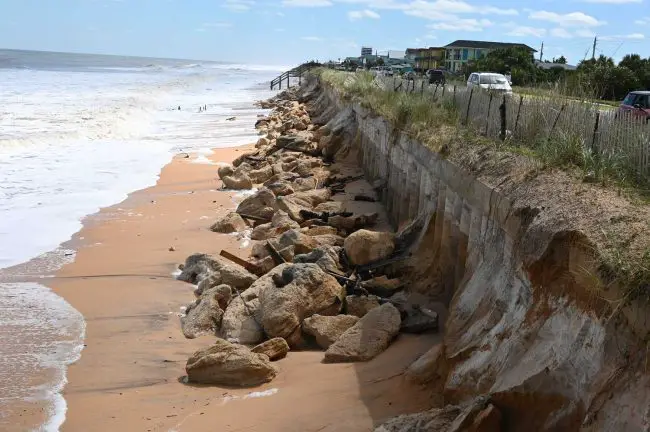 The sea wall's pilings are now exposed in north Flagler Beach, and there is no high-tide beach. (© FlaglerLive)