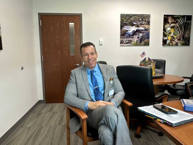 Volusia Flagler YMCA President and CEO Chris Seilkop at Mayor David Alfin's City Hall office on Thursday. (© FlaglerLive)