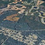 The land of the proposed development, looking west. Seminole Woods Boulevard stretches from left ro right. The ongoing development of Grand Landings, whose residents are objecting to the new development, is to the north. (© FlaglerLive via Goggle Earth)