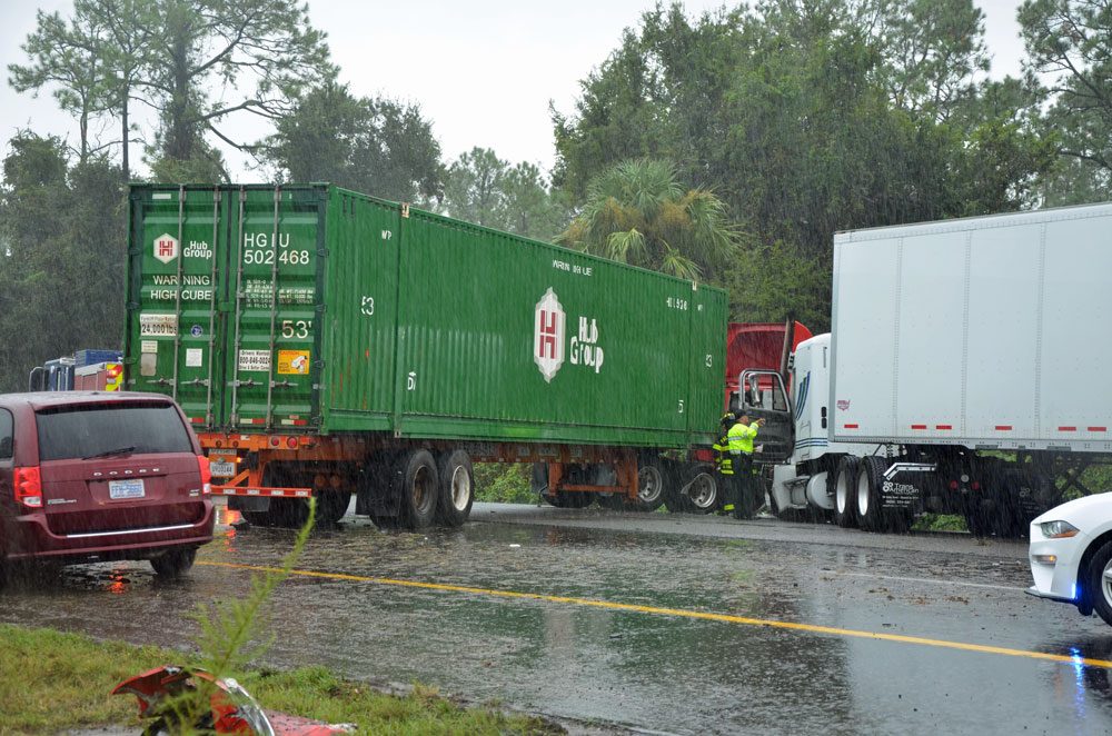 Two of the three semis involved in the crash on I-95 just after noon today, under heavy rain.  The crash shut down all southbound lanes. (© FlaglerLive)