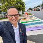 State Sen. Carlos Guillermo Smith stands near the crosswalk outside the Pulse memorial site in Orlando on Aug. 23, 2025. State workers had removed Gay Pride colors at the site, but activists used chalk to restore the colors. The state later repaved the site. (Via Smith’s X feed)