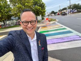 State Sen. Carlos Guillermo Smith stands near the crosswalk outside the Pulse memorial site in Orlando on Aug. 23, 2025. State workers had removed Gay Pride colors at the site, but activists used chalk to restore the colors. The state later repaved the site. (Via Smith’s X feed)