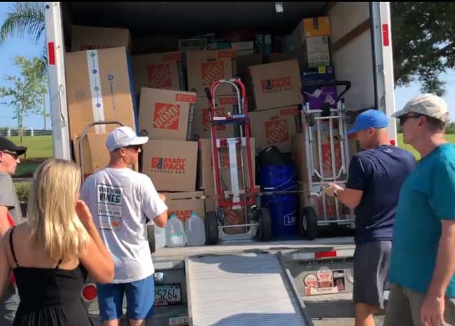 Shane Bonner, second from left, readings a truckload for delivery to docks in Jupiter, then on to the Bahamas, where his own connections are ensuring that the materials end up in the right hands. (Facebook)