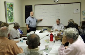 Rabbi Merrill Shapiro, standing, and Rev. Robert Elfvin, sitting, right,  have led the interfaith seminar since December. (c FlaglerLive)