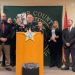 Sheriff Rick Staly held up one of the many vanity selfies by one of the suspects that helped detectives connect dots and eventually serve arrest warrants on those involved in the shooting deaths of Noah Smith and Keymarion Hall. (© FlaglerLive via Facebook live video)