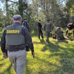 Sheriff Rick Staly, gun drawn, at the scene of an apprehension in the L-Section today. (FCSO)