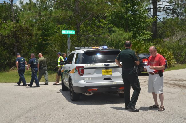 Sheriff Rick Staly had been on his way to Daytona Beach with his wife when he heard the call on the incident, and changed course. Click on the image for larger view. He was reviewing a timeline of the incident shortly after the suspect was apprehended. (© FlaglerLive)