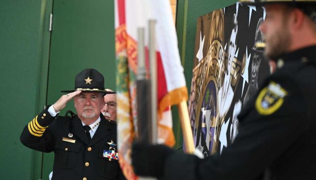 Sheriff Rick Staly saluting the color guard. (© FlaglerLive)