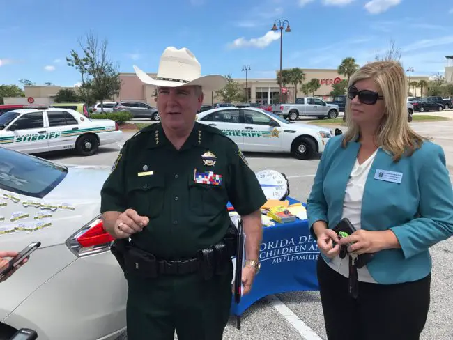 Sheriff Rick Staly at today's demonstration, with Patricia Medlock, regional director for the Department of Children and Families’ northeast region. Click on the image for larger view. (© FlaglerLive)