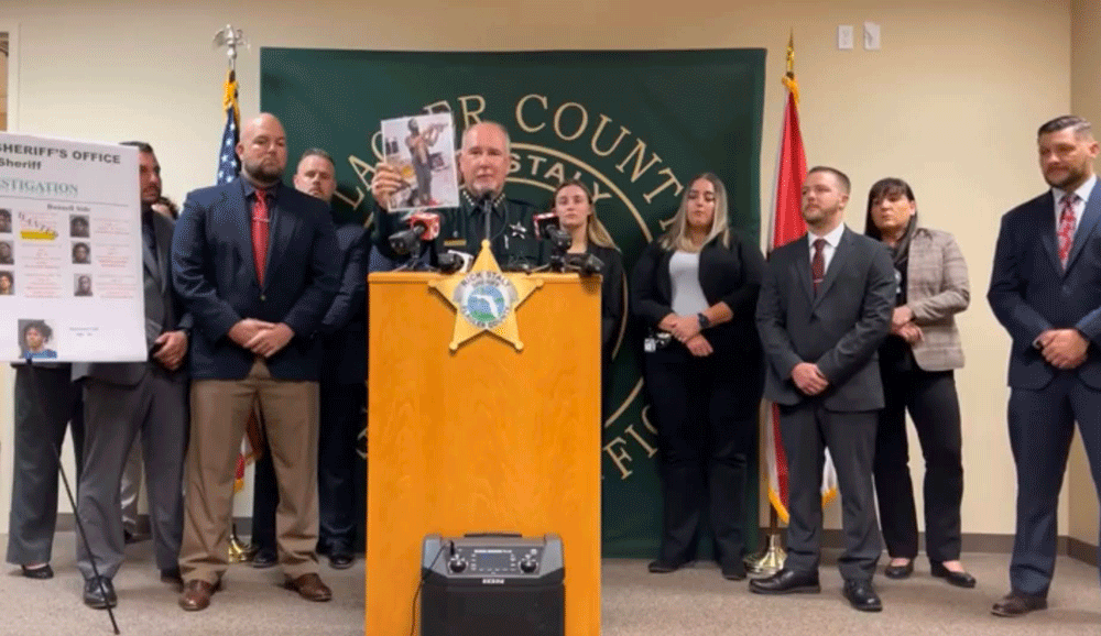 Sheriff Rick Staly held up one of the many vanity selfies by one of the suspects that helped detectives connect dots and eventually serve arrest warrants on those involved in the shooting deaths of Noah Smith and Keymarion Hall. (© FlaglerLive via Facebook live video)