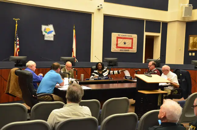 Sally Sherman, the deputy county administrator, sat with county commissioners during a special meeting this morning. Commissioners opted not to sit on the dais. (© FlaglerLive)
