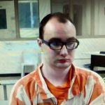 Nathaniel Shimmel, facing a first-degree murder charge in the stabbing death of his mother at their home in August 2017, as he appeared in court through video link from the jail Friday. (© FlaglerLive)
