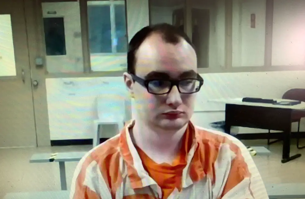 Nathaniel Shimmel, facing a first-degree murder charge in the stabbing death of his mother at their home in August 2017, as he appeared in court through video link from the jail Friday. (© FlaglerLive)