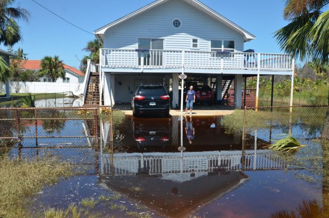 Carol Siboni in front of her house on Surf Drive, in Marineland Acres. Click on the image for larger view. (c FlaglerLive)