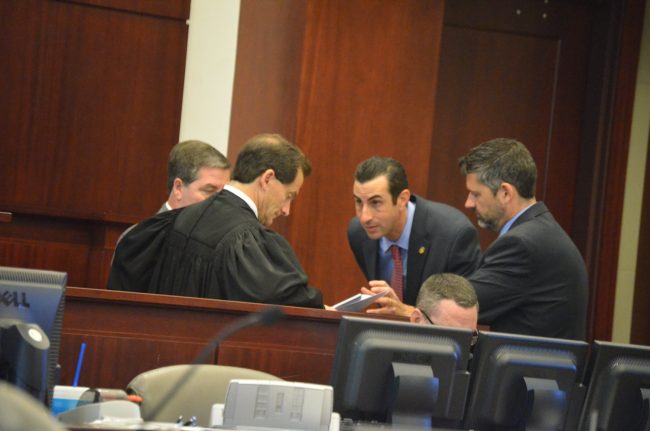 A sidebar between Judge Craig, Assistant State Attorneys Jason Lewis, Joe LeDonne, and Assistant Public Defender Bill Bookhammer. Click on the image for larger view. (© FlaglerLive)