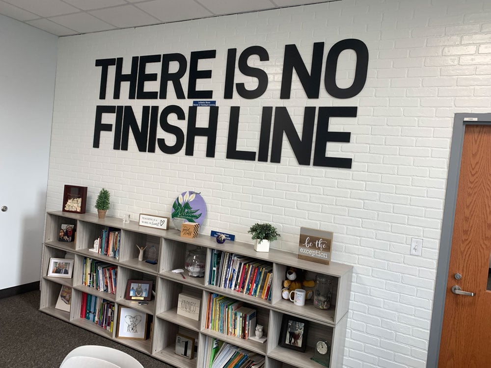 There Is No Finish Line: the sign used to hang in Superintendent LaShakia Moore's office before she got the top job, and now hangs in the administrative offices at Flagler Palm Coast High School. The line has been the theme of school officials' reaction to the district returning to an A. (© FlaglerLive)
