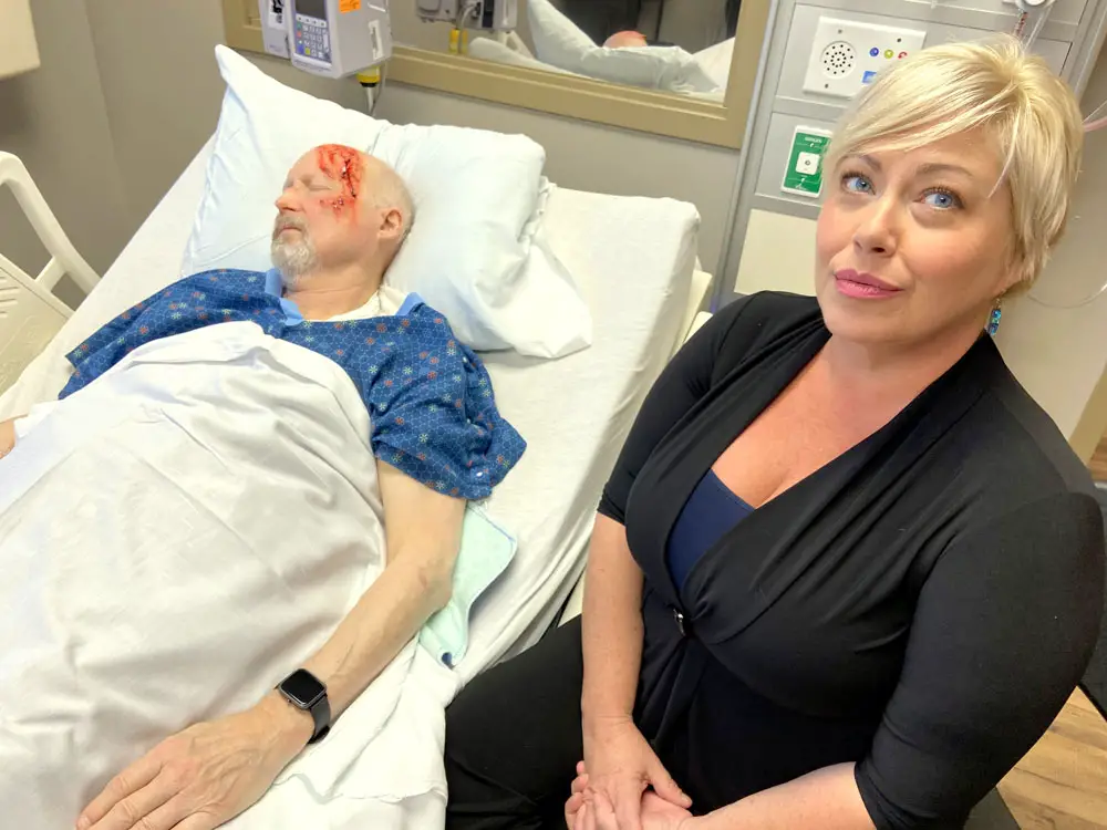 New Smyrna Beach resident Mandee Coomer and her “husband,” Orlando resident Hood Roberts, are actors who participate in simulated medical scenarios at AdventHealth Palm Coast. (© FlaglerLive)