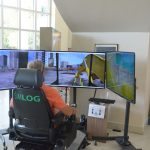 Flagler Techninical Institute, the district's trade school, and the Flagler Education Foundation displayed FTI's new heavy equipment simulator in the lobby of the Government Services Building last week, giving anyone a chance to have a goo, without causing too much damage. (© FlaglerLive)