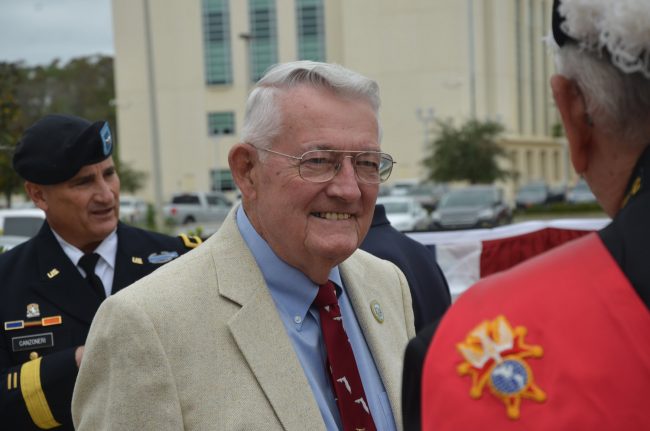 Sisco Deen, Flagler County's Veteran of the Year, served two decades in various branches of the military. His three sons have also served. In the background is Army National Guard Brigadier General Mike Canzoneri, who was today's keynote speaker. (© FlaglerLive)