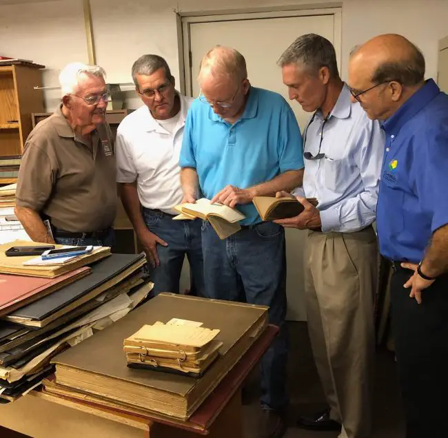 Sisco Deen, left, transferring historical survey books to the county property appraiser's office, with--from left--Todd Largacci, Jimmy Phillips, Property Appraiser Jay Gardner, and Al Hadeed. (Al Hadeed)