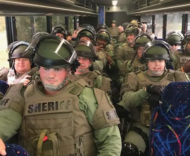 St. Johns County Sheriff's deputies in riot gear heading for Gainesville today. (SJSO)