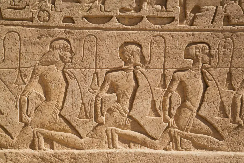 A relief depicting a row of captives, carved into the Sun Temple at Abu Simbel in Egypt. 