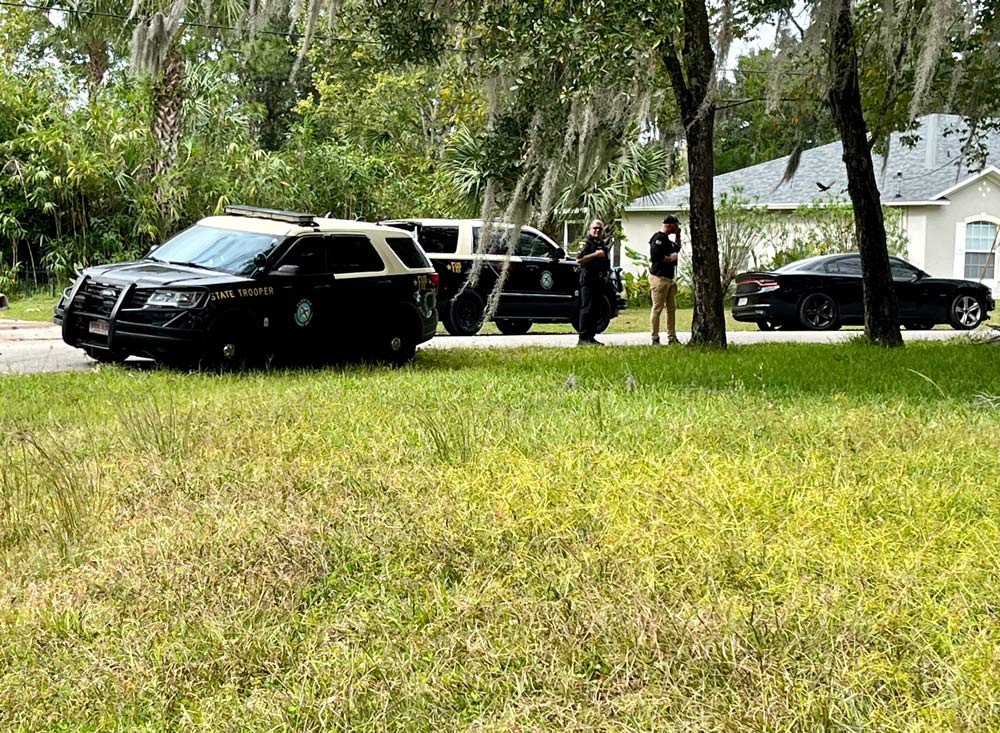 Some of the Florida Highway Patrol troopers involved in the Oct. 26 chase in Seminole Woods, after the alleged suspect's apprehension on Slow Drift Turn. (© FlaglerLive)