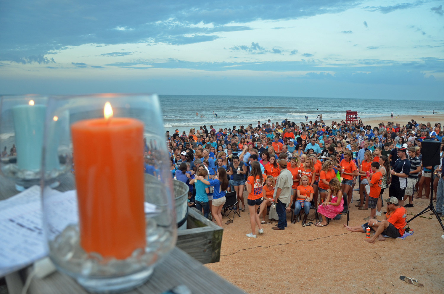The orange candle was for Lane, the blue for Meredith: favorite colors of two teens remembered in a vigil in Flagler Beach this evening. Click on the image for larger view. (© FlaglerLive)