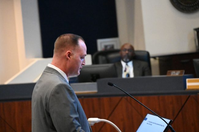 Interim Chief Brannon Snead addressing the city commission Monday. City Manager Alvin Jackson is in the background. (© FlaglerLive)