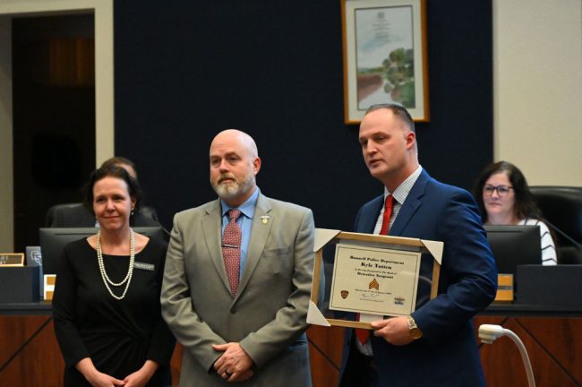 Interim Chief Snead with Sgt. Kyle Totten and County Judge Andrea Totten. (© FlaglerLive)