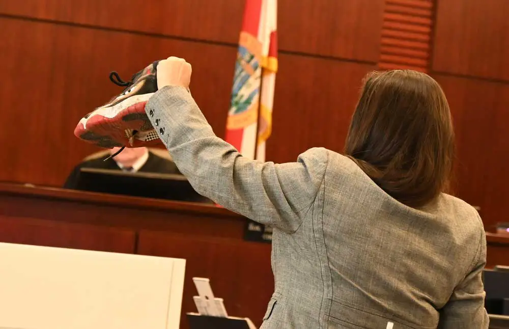 Assistant State Attiorney Tara Libby showing the jury one of the sneakers the prosecution says Carlos DuPree wore the night of the robbery. Jurors apparently matched the sneaker with what they saw in surveillance video to seal DuPree's conviction. (© FlaglerLive)