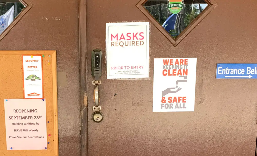 The sign at the entrance to the Social Club of Palm Coast on Old Kings Road. It did not stop patrons from taking off their masks once inside and triggering superspreader events in late August. The club reopened on Monday after a hiatus for cleaning. (© FlaglerLive)
