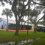 The property owner at a house on flood-prone South Flagler Avenue installed a water-hose barrier in hopes of staving off floodwaters from Hurricane Milton's storm sturge on the Intracoastal. The Intracoastal is only a few feet away from Flagler Avenue, and barely a few in ches below its asphalt. (© FlaglerLive)