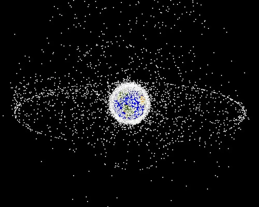 Debris plot by NASA. A computer-generated image of objects in Earth orbit that are currently being tracked. Approximately 95% of the objects in this illustration are orbital debris, i.e., not functional satellites. The dots represent the current location of each item. The orbital debris dots are scaled according to the image size of the graphic to optimize their visibility and are not scaled to Earth. The image provides a good visualization of where the greatest orbital debris populations exist. This image is generated from a distant oblique vantage point to provide a good view of the object population in the geosynchronous region (around 35,785 km altitude). Note the larger population of objects over the northern hemisphere is due mostly to Russian objects in high-inclination, high-eccentricity orbits.