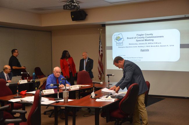 Only three commissioners showed up for today's special meeting: Commissioner Dave Sullivan and Joe Mullins, on either side of the table, and Commission Chairman Don O'Brien, speaking with Deputy County Administrator Sally Sherman. (© FlaglerLive)