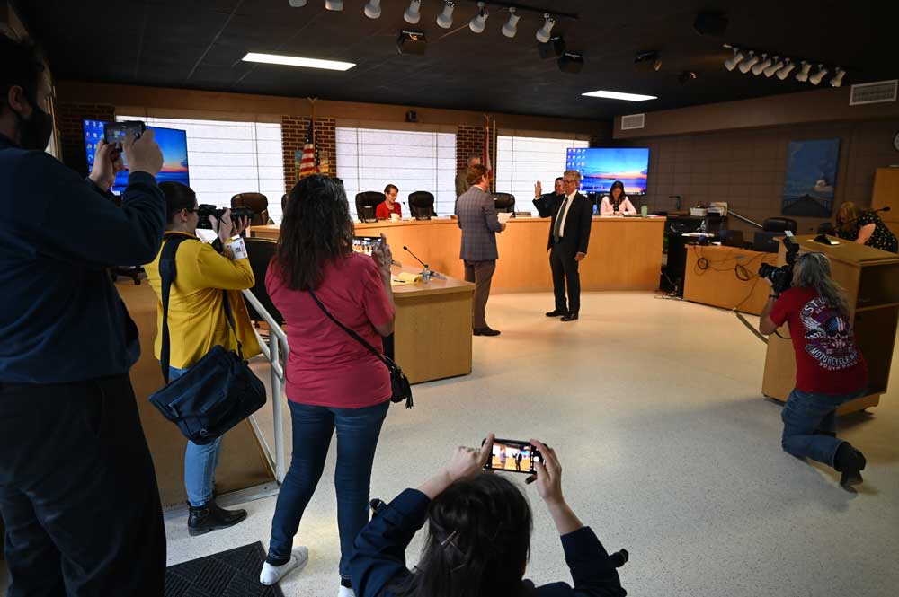 Scott Spradley's and Rick Belhumeur's swearing-in Thursday at the Flagler Beach City Commission drew more lenses than usual, as had the election: Spradley won with over 1,000 votes, nearly twice as many as Belhumeur in second place and more than any candidate previously. (© FlaglerLive)