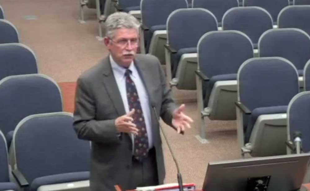Bankruptcy attorney Scott Spradley addressing the County Commission this evening about the case he's handling for the county, against the lone hold-out in a dune-reparation project in Flagler Beach. (© FlaglerLive via Flagler County video)