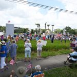 Today's anti-Trump demonstration on State Road 100, one of four in Palm Coast and Flagler Beach, drew upwards of 500 people who stretched over 1,000 feet along the highway, in places several rows deep. (© FlaglerLive)