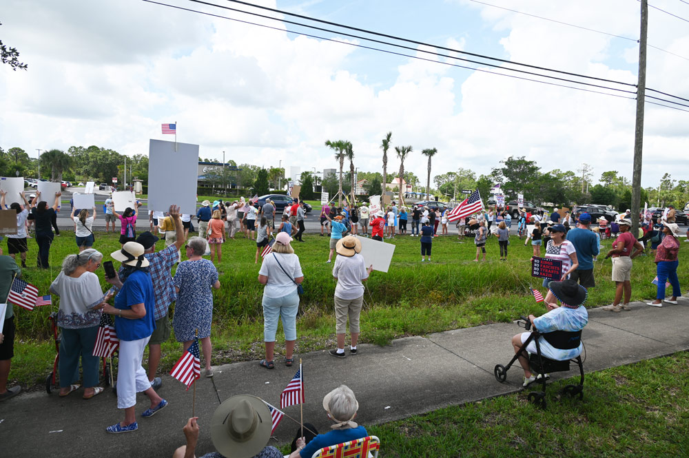 Today's anti-Trump demonstration on State Road 100, one of four in Palm Coast and Flagler Beach, drew upwards of 500 people who stretched over 1,000 feet along the highway, in places several rows deep. (© FlaglerLive)