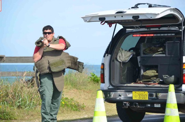 A member of the St. Johns County Sheriff;'s Office's Bomb Squad gearing up. Click on the image for larger view. (c FlaglerLive)