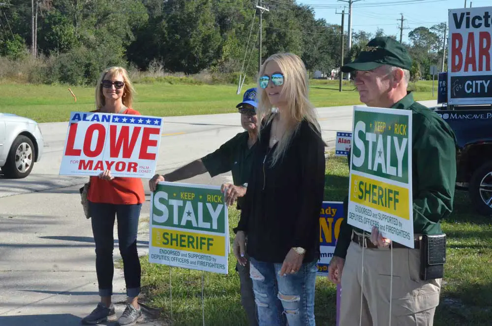 Proximity is not endorsement: Sheriff Rick Staly, with his wife Debbie, had briefly stopped to campaign at the VFW voting precinct off Old Kings Road on Election day in 2020, when an Alan Lowe campaign volunteer was also campaigning--at the time, for mayor. Staly has never endorsed Lowe, and said today he was not endorsing anyone in the Palm Coast council races. (© FlaglerLive)