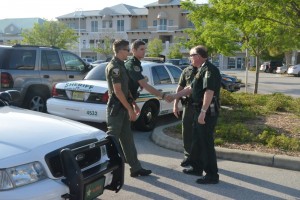 Near the Palm Coast Precinct at City Marketplace, saying goodbye to cops almost as young as Staly was when he started in 1974. Click on the image for larger view. (© FlaglerLive)