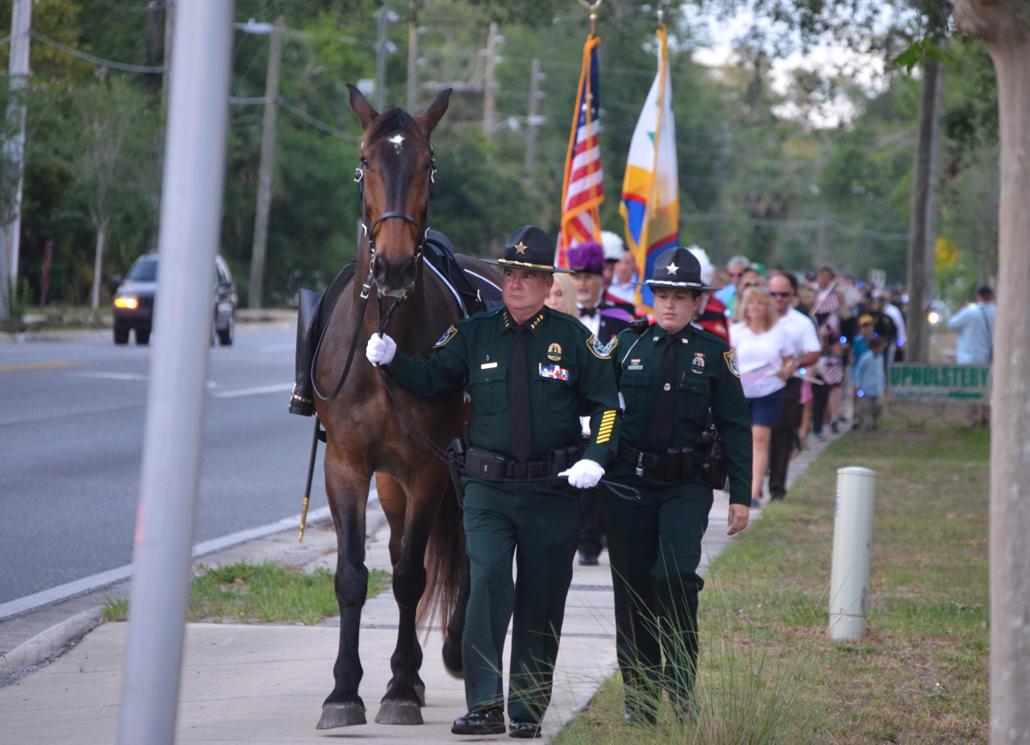 Sheriff Rick Staly, with a riderless horse symbolizing the loss of fallen officers, leads a procession from the county courthouse to the Sheriff's Operations Center ahead of a ceremony Thursday evening. Click on the image for larger view. (© FlaglerLive)